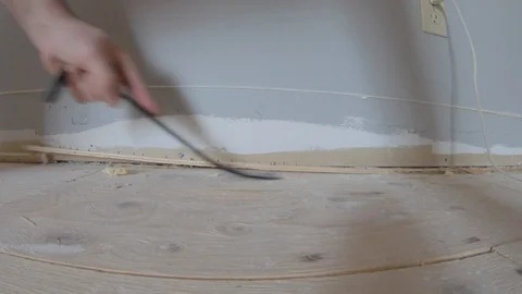 Pulling up old carpets in a renovated house Stock Footage 124673749
