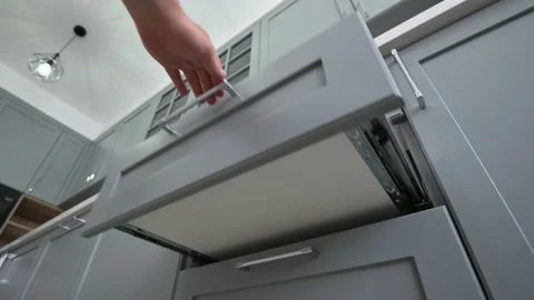 Pulling out and closing the drawer at modern classic gray kitchen Stock Footage 156353023