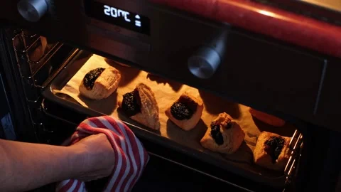 Pulling out a baking tray full of freshly baked Leaf Fat Pastry Stock Footage 270556535