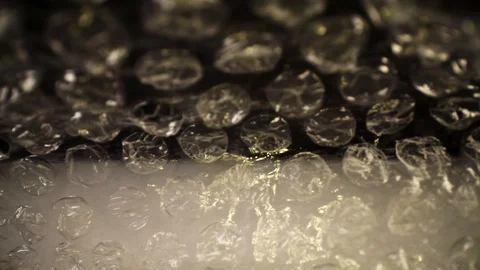 Pulling out of a bubble wrap bag, top of the bag moves slightly, focused Stock Footage 115911633