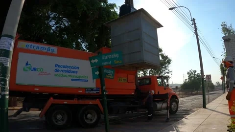Pulling out a buried garbage container with a truck Stock Footage 148796360