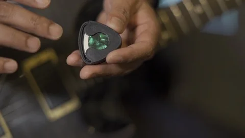 Pulling out guitar pick Stock-Footage 114395396