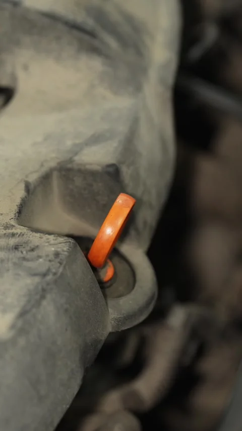 Pulling out the oil dipstick from a dusty engine bay. Stock Footage 341485187