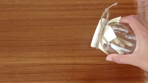 Pulling out a paper of goal from a jar Stock Footage 151023553