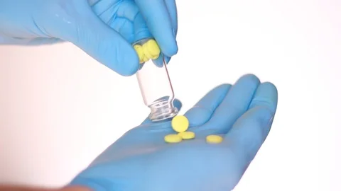 Pulling out pills in hand dressed in latex glove 動画素材 96985882
