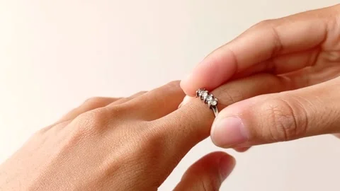 Pulling out a ring from a beautifull hand Stock Footage 145461665