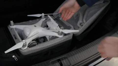 Pulling out a white remote control from a black backpack Stock Footage 88334736