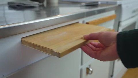 Pulling Out Wooden Cutting Board from Kitchen Drawer Stock Footage 328012472