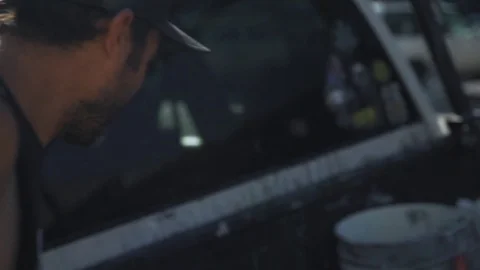 Pulling paint buckets out of a truck Stock Footage 74590238