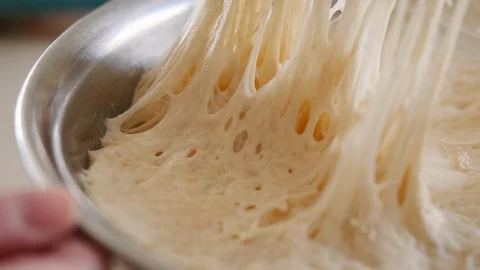 Pulling Plastic Wrap Off Raw Bread Dough Stock Footage 129553621