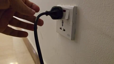 Pulling the plug from the elctric socket. Stock Footage 283603193