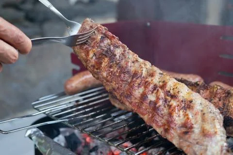 Pulling pork ribs grilled over the coals. Concept of food. Foto stock