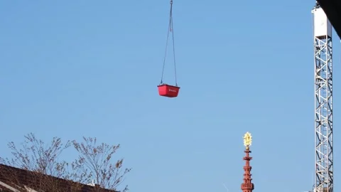 Pulling up a red container with a crane against the clear blue sky Stock Footage 313272633