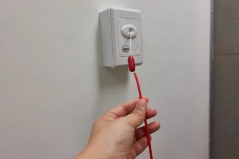 Pulling of red emergency call alert in the hospital toilet Stock Photos