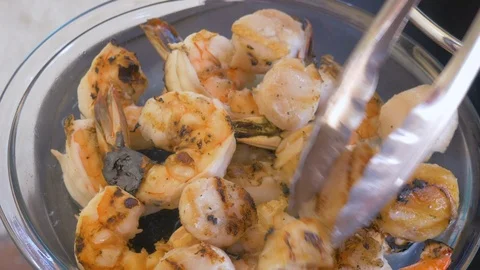Pulling Scallops and Shrimp off a Grill with Tongs in 4k Stock Footage 99016603