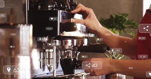 Pulling shot, barista in red apron holding portafilter using espresso machine on Stock Photos