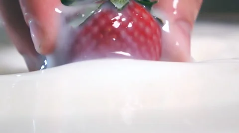 Pulling Strawberry from milk Stock Footage 62588813