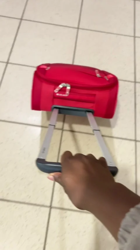 Pulling a suitcase through the airport Stock Footage 337857850