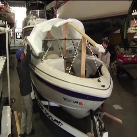 Pulling Tarp over Boat Stock Footage 69527913