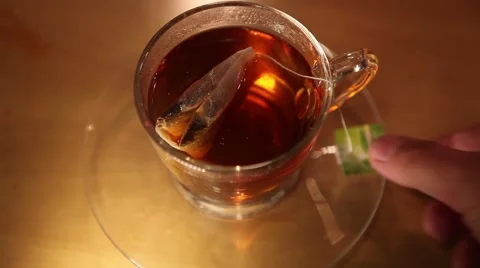Pulling teabag out of glass Stock Footage 50597449