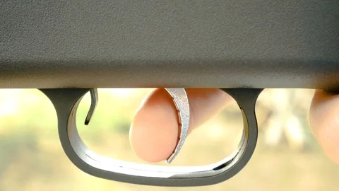 Pulling the trigger of a gun in different ways Vídeos de archivo 115206435