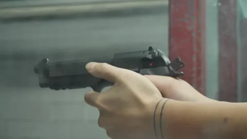 Pulling the trigger at shooting range behind the glass dump round black Stock Footage 245791807