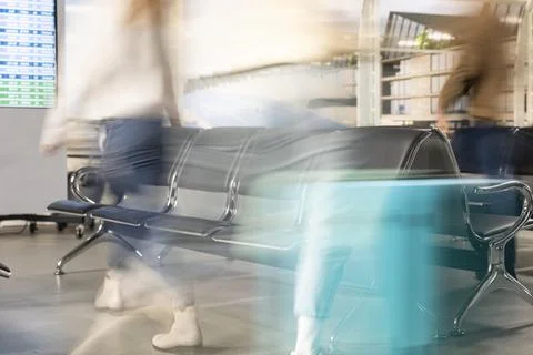 Pulling trolleys, fast motion blur and close up of travelers in busy airport Stock Photos