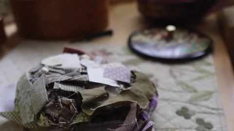 Pulling varied fabric scraps from a circular container Stock Footage 315084830