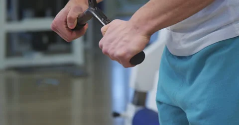 Pulling weight machine at gym Stock Footage 38730243