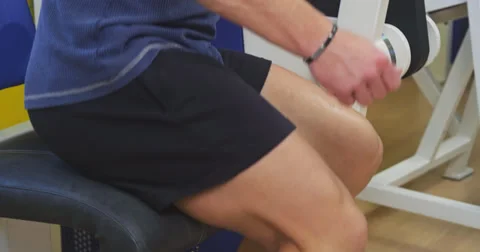 Pulling weight machine at gym Stock Footage 38731914