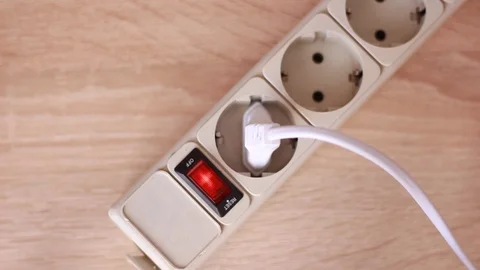 Pulling white cable out of socket Stock Footage 86055471