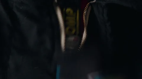 Pulling up the zipper on racing attire. Stock Footage 248759663