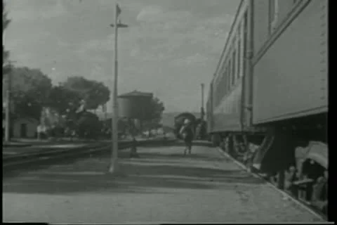 Pullman porter putting down foot stool as train pulls into station Stock Footage 11347443