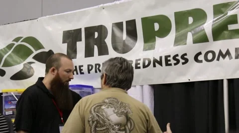 Pullout Shot of Client Talking with Prepper Exhibitor at Trade Show Stock Footage 64906982