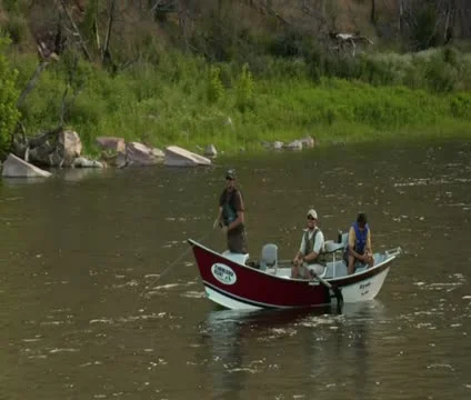 Pullout shot of flyfishing drift boat in calm river Stock Footage 21652325
