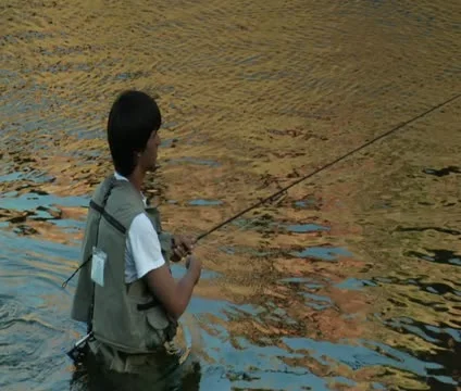 Pullout shot on young flyfishing Stock Footage 21653764