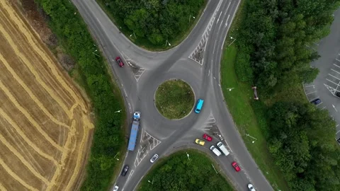 Pullout from a traffic roundabout surrounded by rural fields Stock Footage 247000903