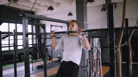 Pulls up on bar in gym Stock Footage 112947993