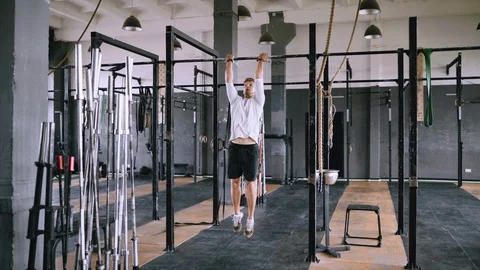 Pulls up on bar in gym Stock Footage 112949462