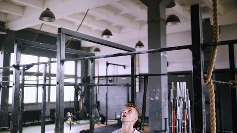 Pulls up on bar in gym Stock Footage 112949976