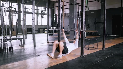 Pulls up on bar in gym Stock Footage 113010128