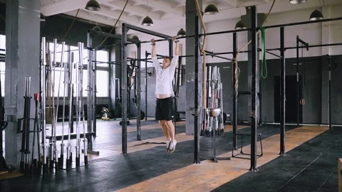 Pulls up on bar in gym Stock Footage 114802328
