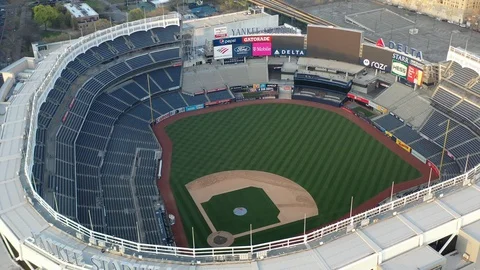 Pulls from an empty Bronx sports venue toward dense city blocks Vídeo Stock 128549584