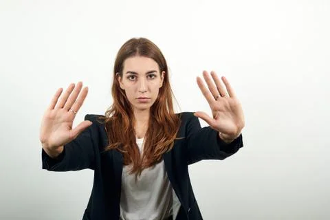 Pulls hand forward camera, says no, disagrees, frowns face, gives warning 스톡 사진