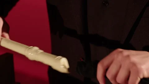 Pulls out a flute from a case. hands of a man in a black tuxedo Stock Footage 266269773