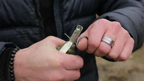 Pulls out a hand grenade  스톡 동영상 135995825