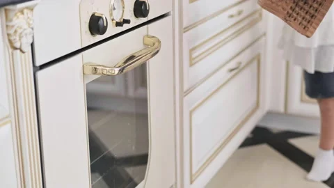 Pulls out of oven sponge cake. Woman's hands taking out baking pan from oven Stock Footage 138342489