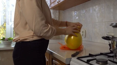 Pulls pomelo out of the package Zoom 4K Stock Footage 112585256