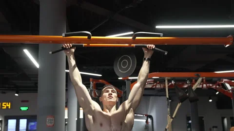 Pullup. strong sportsman practicing pullup in sport gym. sportsman do pullup Stock Footage 226554415