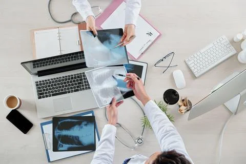 Pulmonologists comparing lungs x-rays Stock Photos